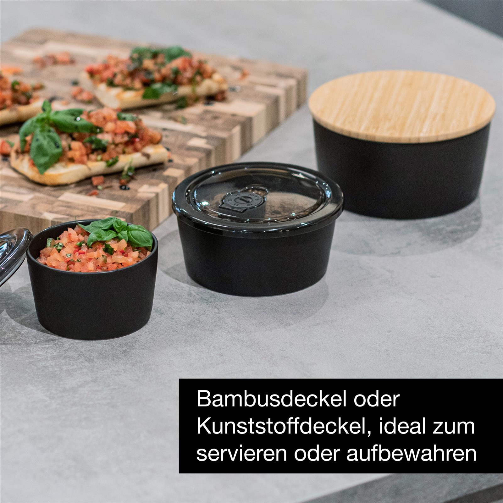 Schwarze Porzellanschüsseln im modernen Design auf Holzuntergrund Zwei stapelbare Porzellanschüsseln in elegantem Schwarz mit matter Oberfläche, auf einem hellen Untergrund präsentiert.