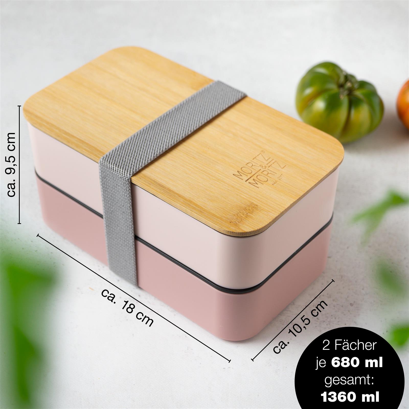 Bild der pinken Bento-Box mit vielfältigem Inhalt Bento Box in Pink mit verschiedenen Fächern, ideal zum Verstauen von Lebensmitteln, stilvoll und praktisch für Mahlzeiten unterwegs.